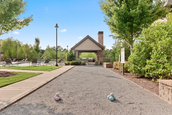 a pathway leading to a pavilion with balls on the ground at The Ridge at Chenal Valley, Little Rock