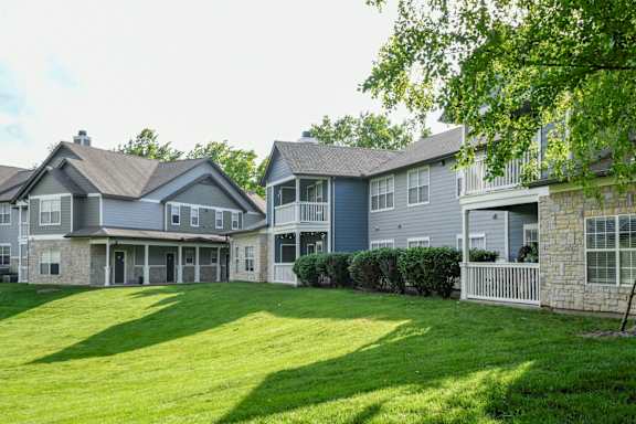 A row of houses with green lawns in front. at Sandstone Creek, Overland Park, KS