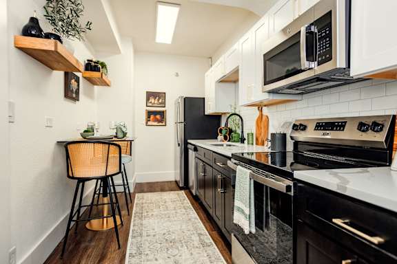 A kitchen with black appliances and white cabinets. at Parkview Apartments, Memphis, TN, 38104