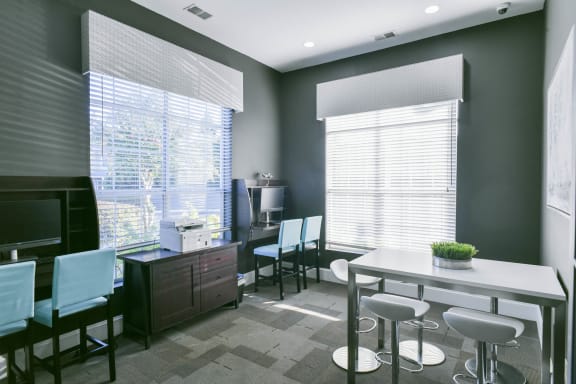 a modern office with a table and chairs