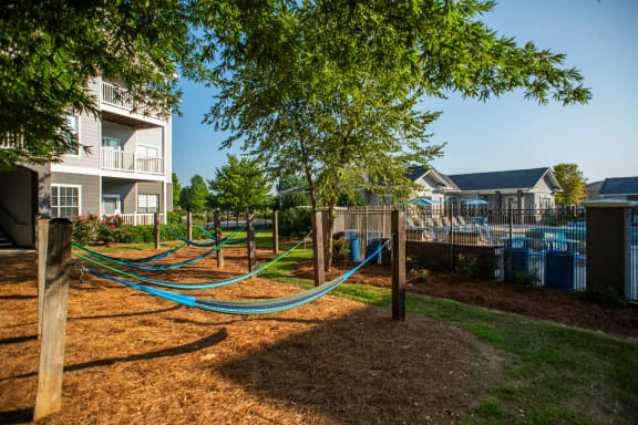 a playground with hammocks in front of an apartment building at The Shallowford, Chattanooga, TN, 37421
