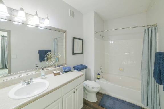 a bathroom with a sink toilet and shower and a mirror at The Shallowford, Chattanooga