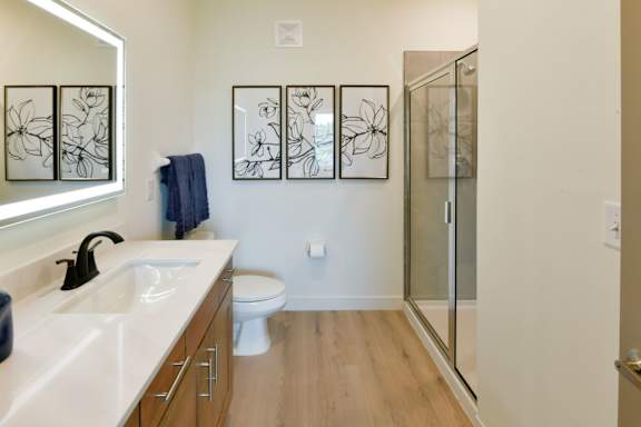 A sleek bathroom with a glass door shower