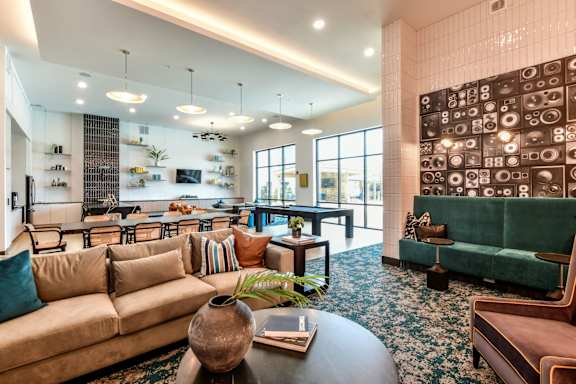 A lounge room with a large couch and a coffee table.