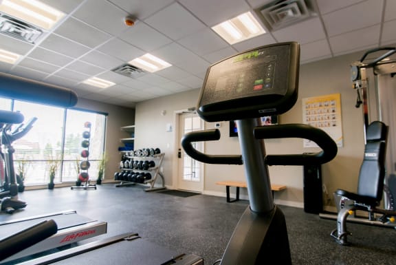 a fitness room with treadmills and other exercise equipment at The Villa at River Pointe, Maumelle, Arkansas