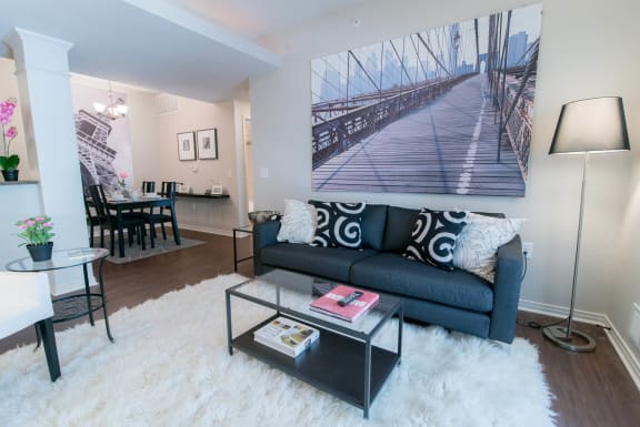 a living room with a couch and a coffee table at The Villa at River Pointe, Maumelle, AR 72213