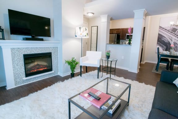 a living room with a fireplace and a television at The Villa at River Pointe, Maumelle, 72213