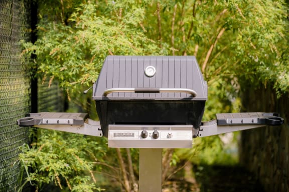 a barbecue grill with a tin roof on a pole at The Villa at River Pointe, Arkansas, 72213