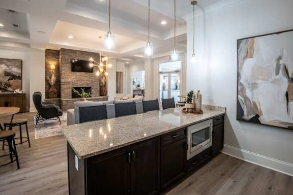 A modern kitchen with a large island and a fireplace. at Hall Creek Apartment Homes, Tennessee, 38002