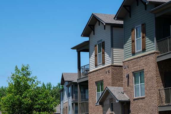 A row of houses with balconies and windows. at Hall Creek Apartment Homes, Arlington, Tennessee