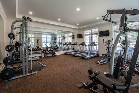 A spacious home gym with a variety of exercise equipment.