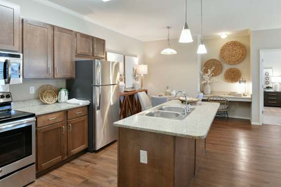 A kitchen with wooden cabinets and a black refrigerator.