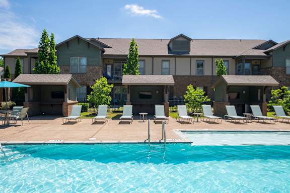 A large house with a pool in front.