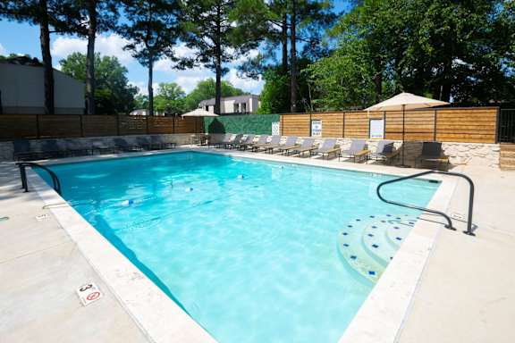 A rectangular pool with a blue tinted water.