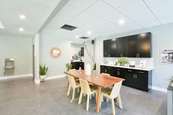 A kitchen with a table and chairs in the middle of the room.