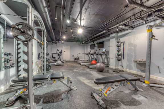 A gym with a variety of equipment including weights and benches.at Iris Luxury Apartments, Tennessee, 38105