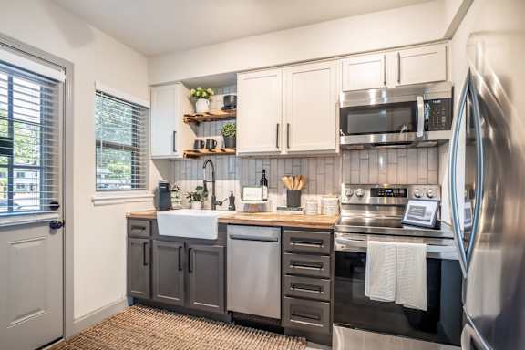 A kitchen with a sink, stove, and refrigerator at Kiwi Goji Apartments, Tennessee, 38111