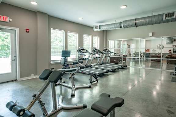 A gym with treadmills, weights, and exercise equipment. at Lakeland Town Square, Tennessee, 38002