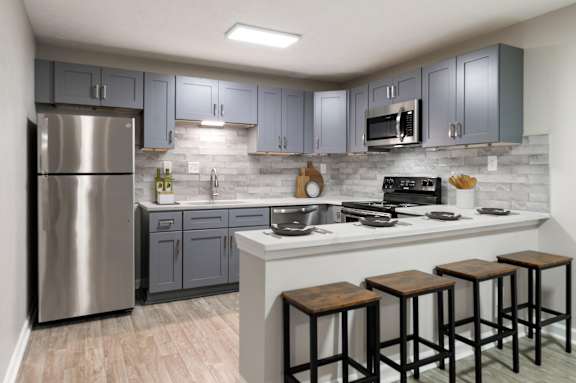 kitchen with blue cabinet at Manchester at Mansell, Roswell, GA