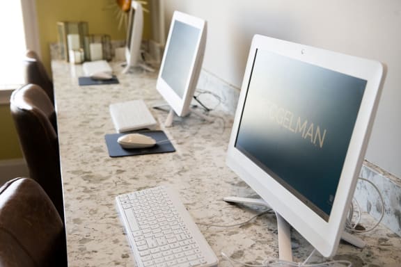 a desk with three computer monitors and a keyboard and mouse