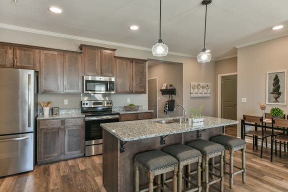 Kitchen with stainless steel appliances and bar at Meridian Park in Collierville, TN 38017