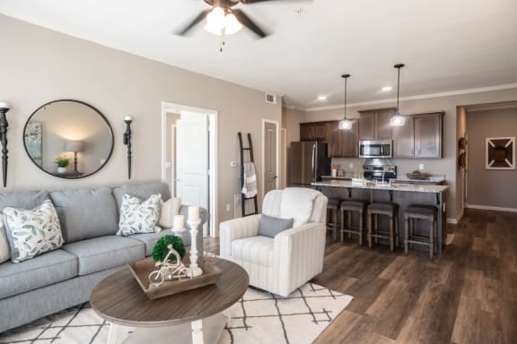 a living room and kitchen with a couch and a table