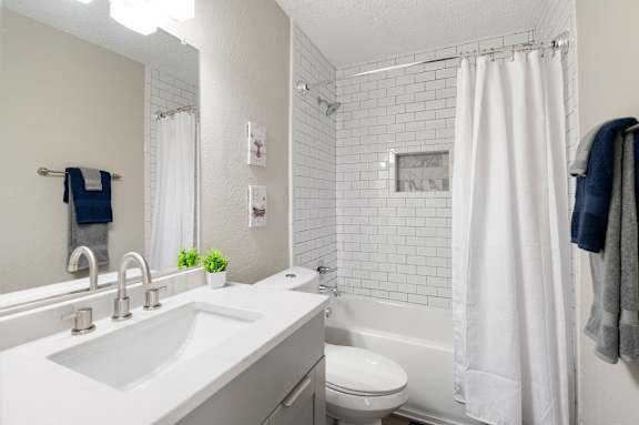 bathroom with sink, toilet and tub at Mill House at East Cobb, Marietta