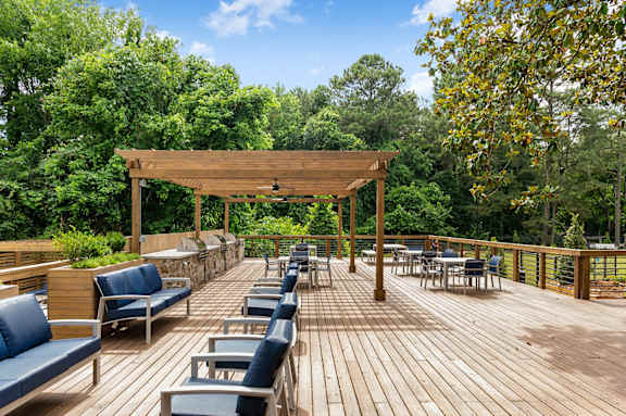 wooden deck with trees and chairs at Mill House at East Cobb, Marietta, 30067