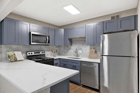 kitchen with blue cabinet and fridge at Mill House at East Cobb, Marietta, GA 30067
