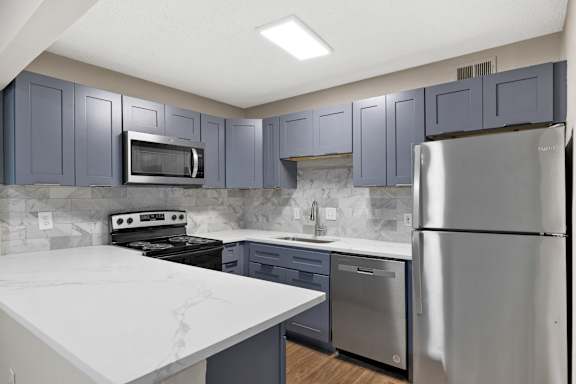 white counter with stove and fridge at Mill House at East Cobb, Marietta