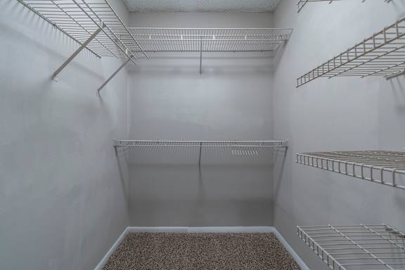 Empty white closet with shelves at Mill House at East Cobb, Georgia