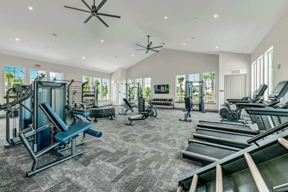 a gym with treadmills and other exercise equipment at Livano Nature Coast, Spring Hill, 34608