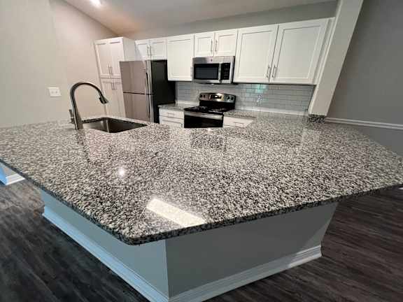 a kitchen with an island with granite counter top at Paradise Island, Jacksonville, FL, 32256