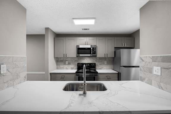 kitchen with a sink with grey cabinet at Station Heights, Alpharetta
