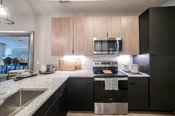 a kitchen with black appliances and granite counter tops