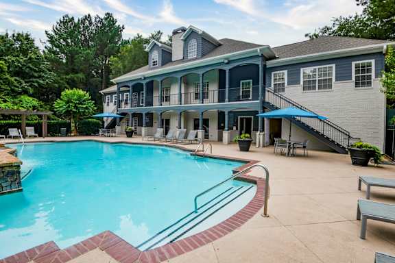 Lounging By The Pool at Sugarloaf Crossing Apartments, Lawrenceville, GA, 30046