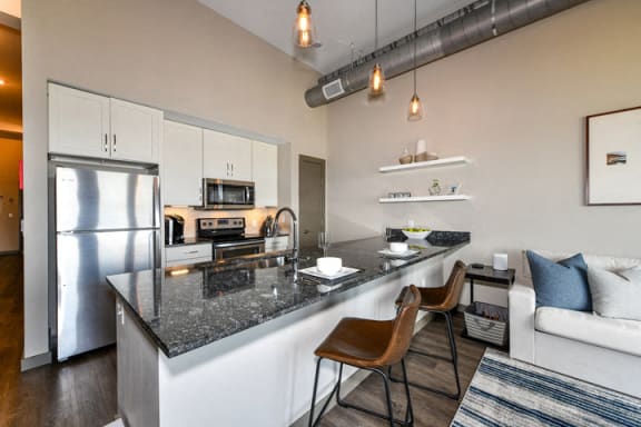 Gourmet Kitchens with Stainless Steel Appliances and White Shaker Style Cabinetry and Brushed Nickel Hardware at Legends at The Tennessee Brewery, Memphis, TN 38103