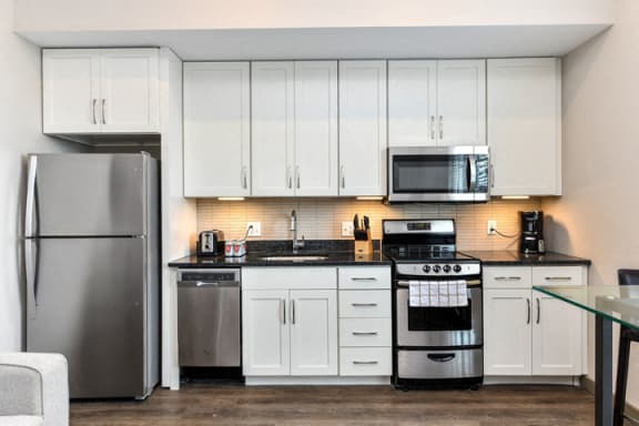 Gourmet Kitchens with Stainless Steel Appliances and White Shaker Style Cabinetry and Brushed Nickel Hardware at Legends at The Tennessee Brewery, Memphis, TN 38103