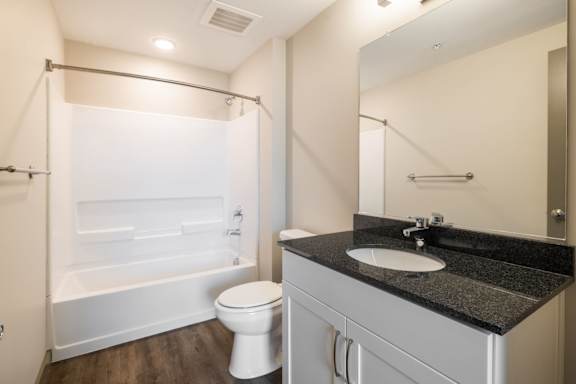 A bathroom with a toilet, bathtub, and sink at The Tennessee Brewery, Memphis, Tennessee