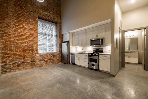 A kitchen with concrete floors and brick wall at The Tennessee Brewery, Memphis