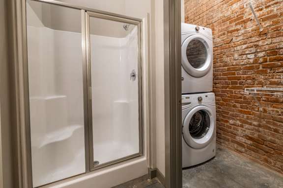 enclosed shower and stackable washer and dryer at The Tennessee Brewery, Memphis
