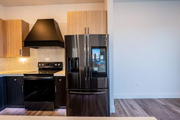 Kitchen with black refrigerator at Chelsea Apartments, Missouri, 63112