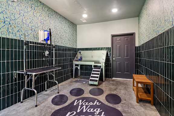A bathroom with a wash hand mat on the floor.