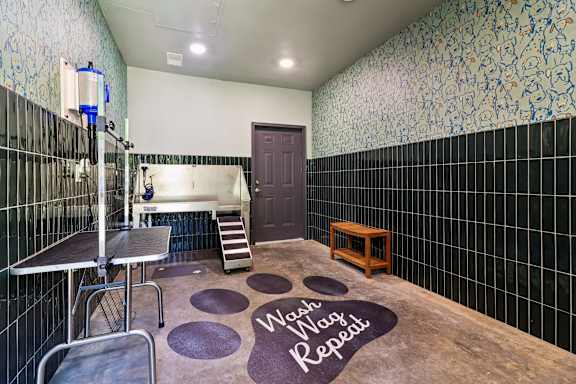 A bathroom with a sign on the floor that says "Wash Wash Repeat".