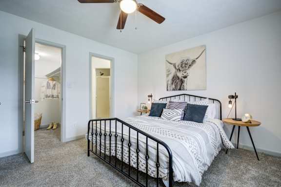 Bedroom with ceiling fan at The Waters at Chenal Apartments, Little Rock