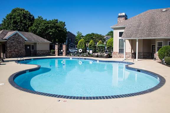 A large swimming pool with a blue tiled edge and a white line on the bottom.