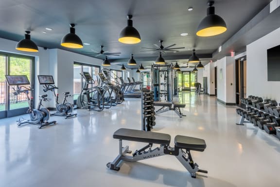 a gym with cardio equipment and weights on the floor at The Livano Tryon, Charlotte