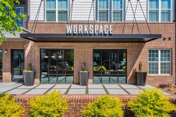 a brick building with a sign that reads workspace at The Livano Tryon, North Carolina, 28213
