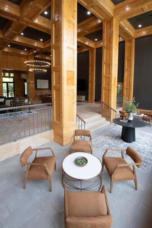 A large room with a table and chairs in the center.