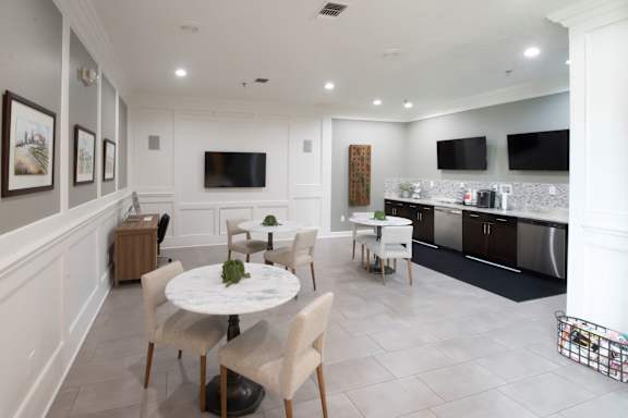 A modern dining room with a white table and chairs.